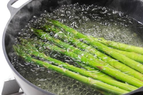 鍋で茹でているグリーンアスパラガス