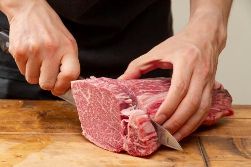 包丁で肉を切る