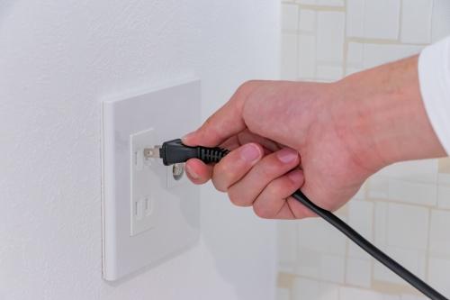 コンセントを挿そうとする手