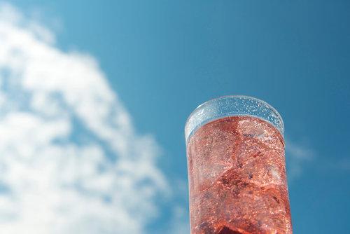 夏の青空と雲、グラスに入ったカシスソーダ